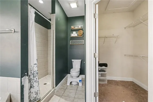 a bathroom with a shower and a toilet