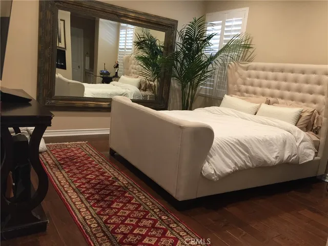 a living room with a couch and a potted plant