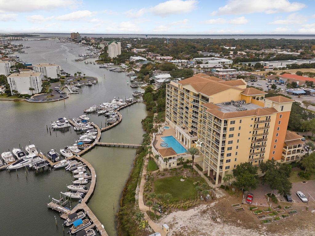 an aerial view of residential houses with outdoor space and ocean view