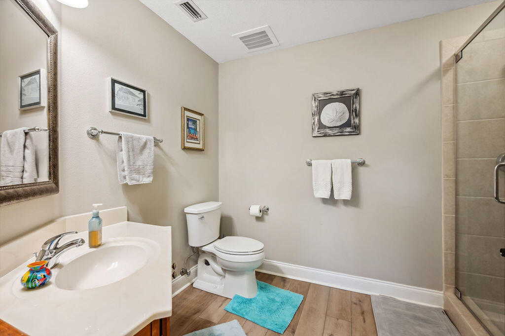 770 Harbor Boulevard, Unit 1D Destin, FL 32541 - Photo 22 of 59 a white toilet sitting next to a bathroom sink