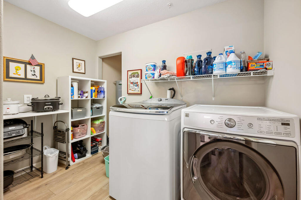 770 Harbor Boulevard, Unit 1D Destin, FL 32541 - Photo 29 of 59 a storage room with washer and dryer