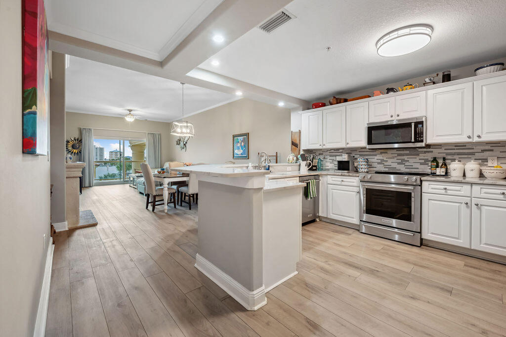 770 Harbor Boulevard, Unit 1D Destin, FL 32541 - Photo 30 of 59 a kitchen with a stove cabinets and a refrigerator