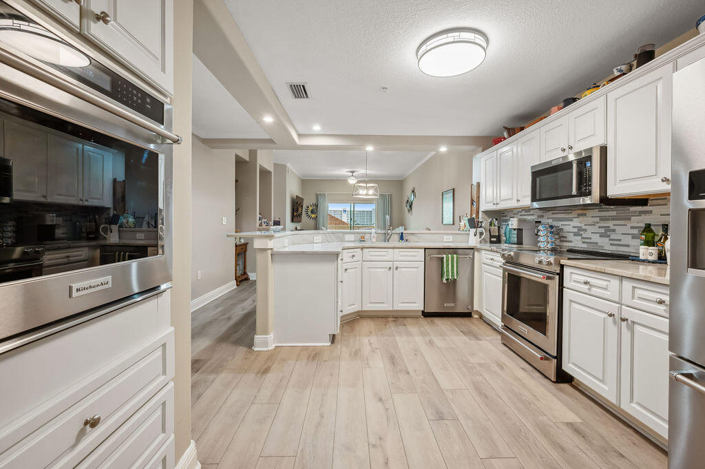 770 Harbor Boulevard, Unit 1D Destin, FL 32541 - Photo 31 of 59 a kitchen with a white cabinets and white appliances