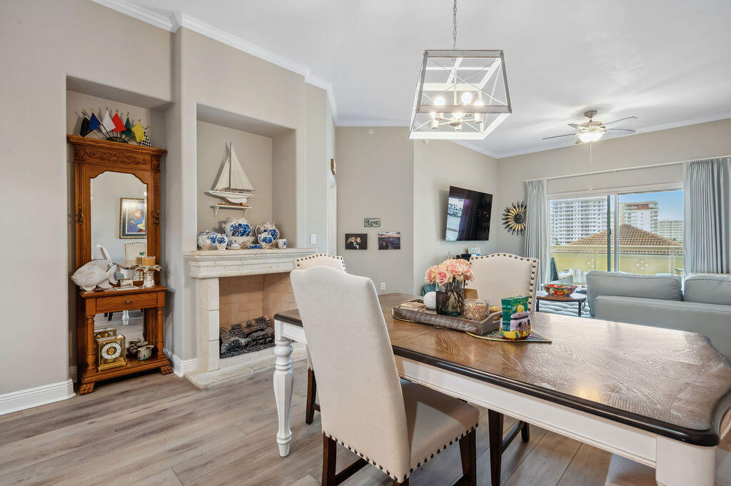 770 Harbor Boulevard, Unit 1D Destin, FL 32541 - Photo 35 of 59 a view of a dining room with furniture a chandelier and wooden floor