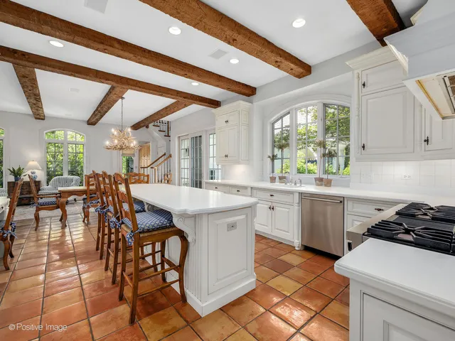 a kitchen with a table chairs and a stove