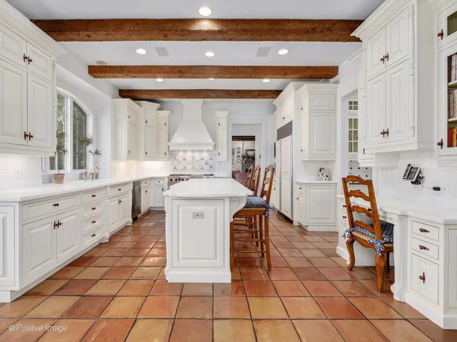 a view of a dining room and livingroom with furniture wooden floor and a chandelier