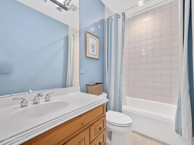 a spacious bathroom with a granite countertop sink and a mirror