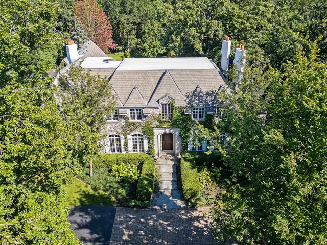 an aerial view of a house with a yard