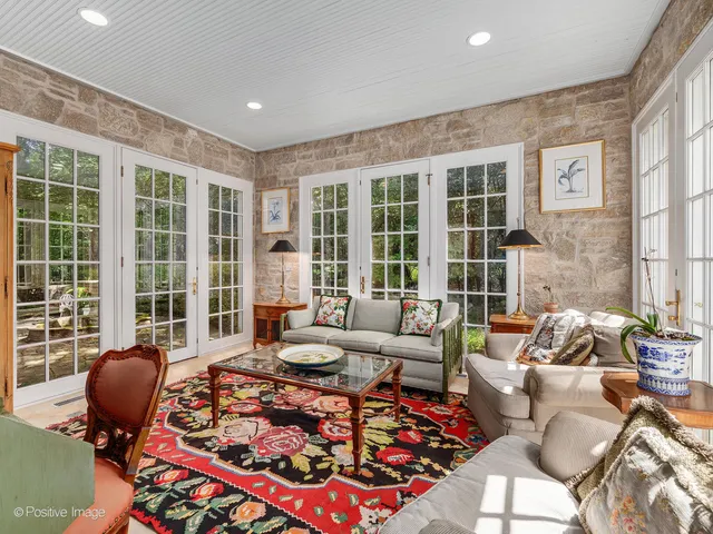a living room with furniture and a floor to ceiling window