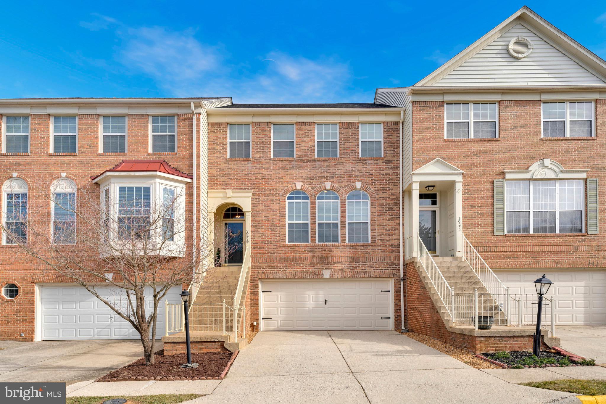 20876 Trinity Square Sterling, VA 20165 - Photo 1 of 50 a front view of a house with a yard