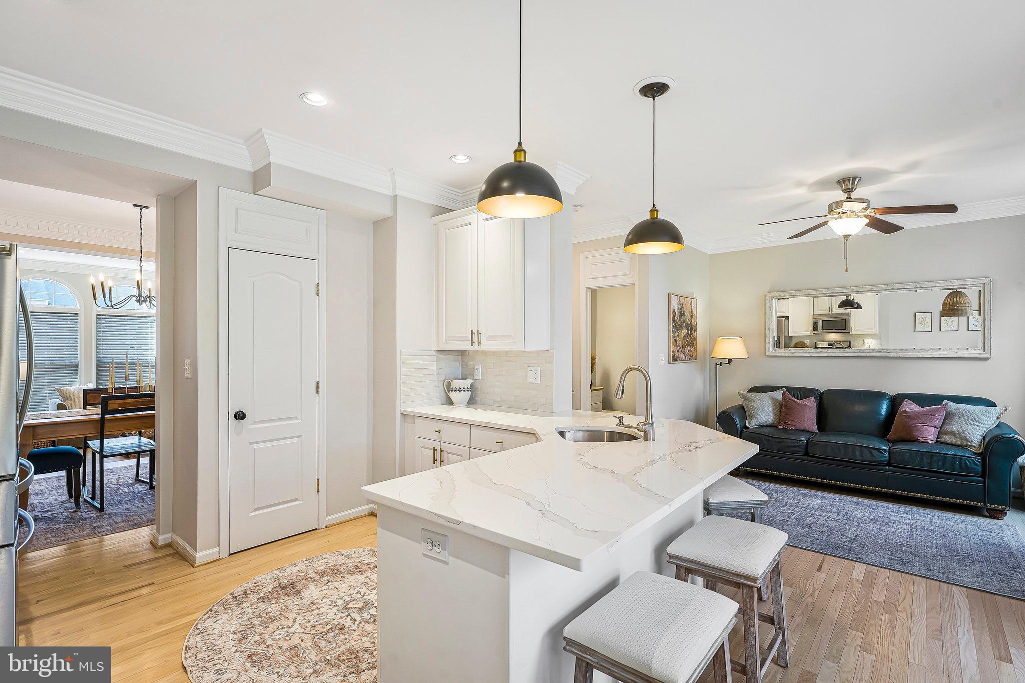 20876 Trinity Square Sterling, VA 20165 - Photo 11 of 50 a living room with furniture a dining table and a chandelier