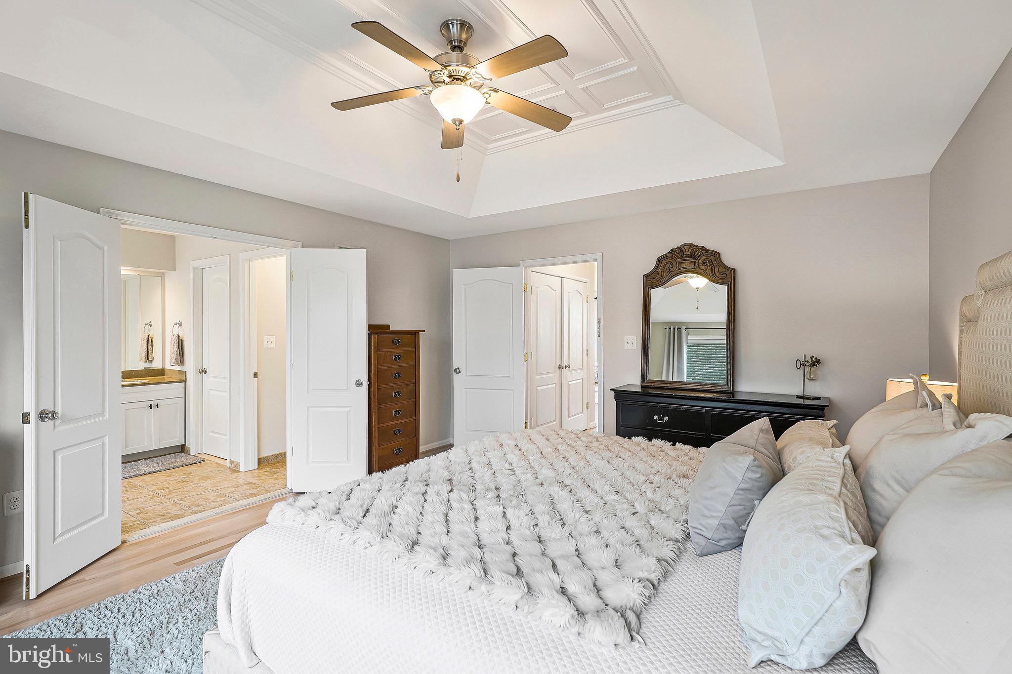 20876 Trinity Square Sterling, VA 20165 - Photo 27 of 50 a bedroom with a large bed and a chandelier