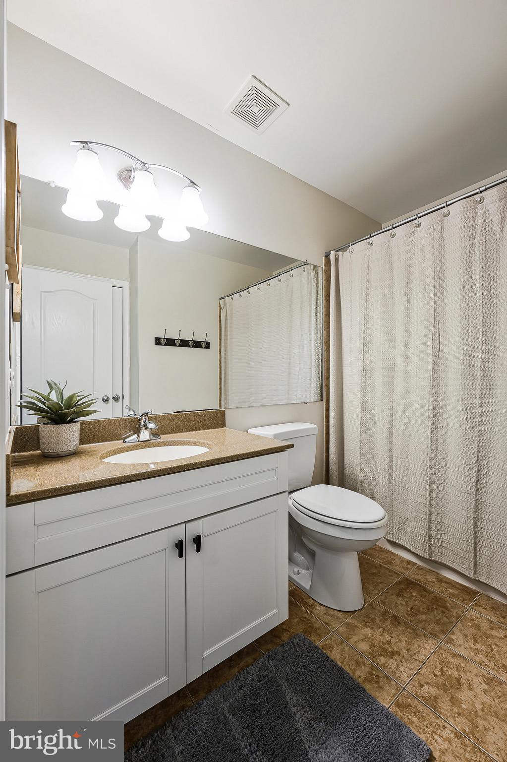 20876 Trinity Square Sterling, VA 20165 - Photo 31 of 50 a bathroom with a toilet sink and mirror