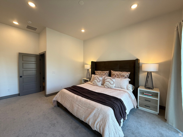 8087 South 615 East, Unit 3 Sandy, UT 84070 - Photo 9 of 23 Carpeted bedroom with recessed lighting and a tall, upholstered headboard