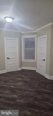 a view of room with hardwood floor and cabinet