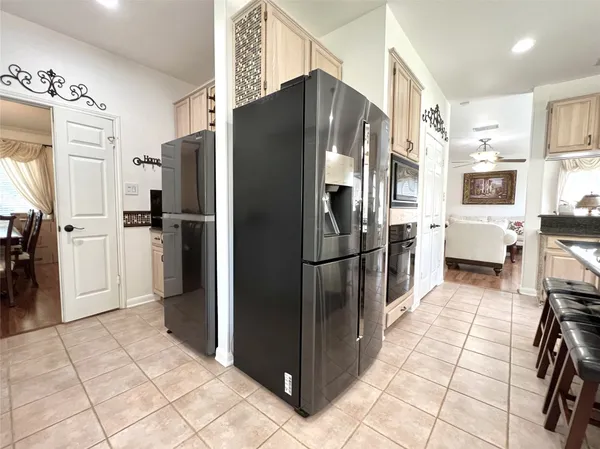 a kitchen with stainless steel appliances a refrigerator and a stove top oven