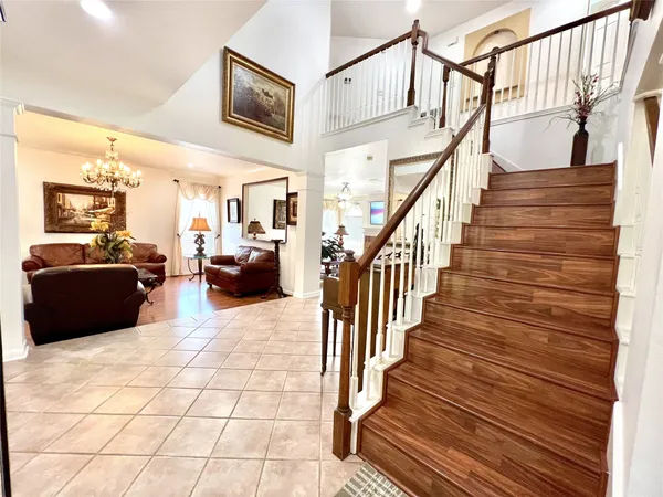 a living room with furniture and a chandelier