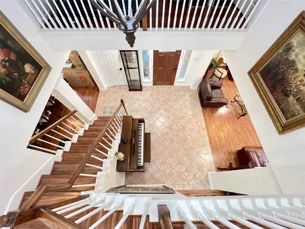 a front view of a house with a garden and trees
