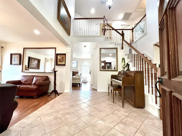 a living room with furniture and a view of kitchen