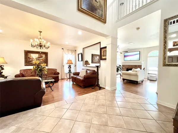 a living room with furniture and a chandelier