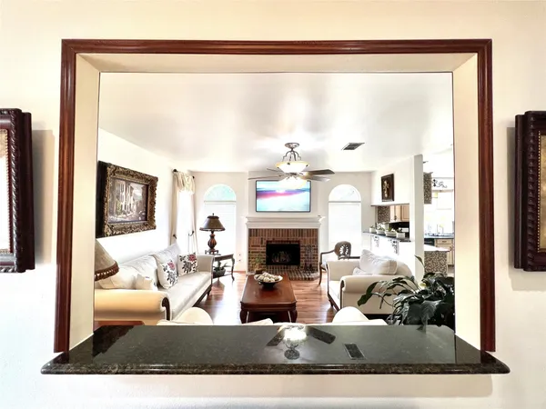 a living room with fireplace furniture and a large window