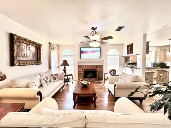 a living room with furniture a fireplace and a chandelier