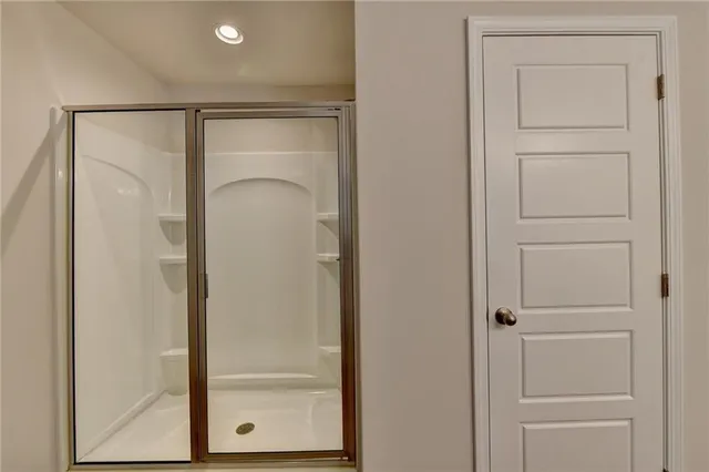 a bathroom with a glass shower door