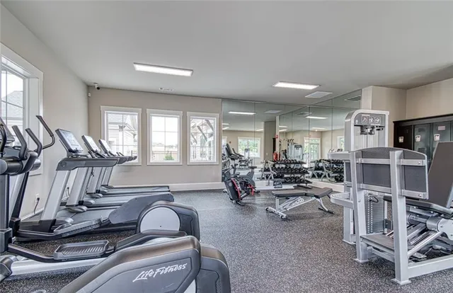 a room with gym equipment and windows