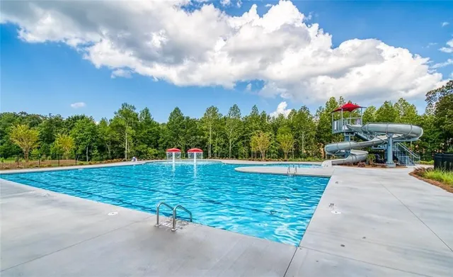 a view of a swimming pool with a yard