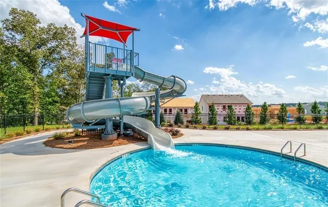 a view of a house with swimming pool and sitting area