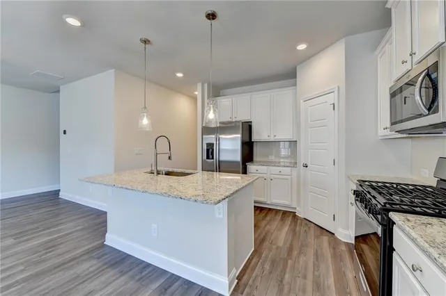 a kitchen with sink cabinets and wooden floor