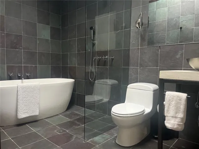 a white toilet sitting next to a bathroom sink