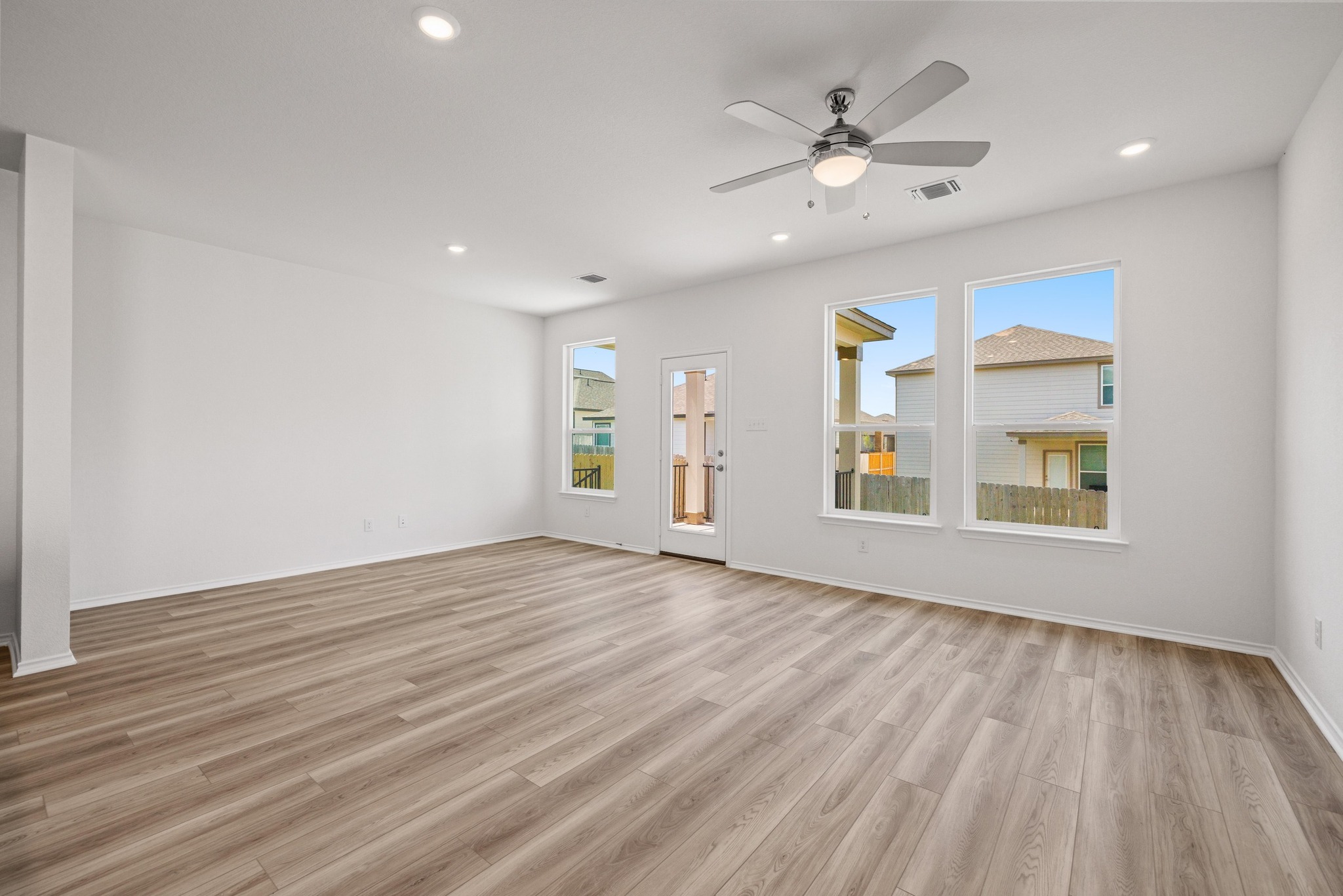 260 Feathers Street Jarrell, TX 76537 - Photo 10 of 34 a view of an empty room with window and wooden floor