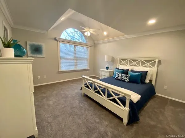 a view of a bedroom with furniture and windows