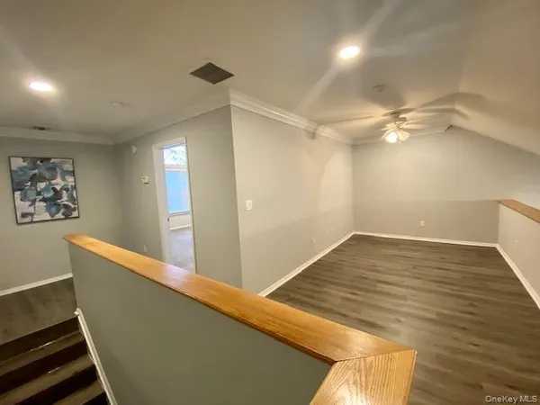 a view of a room with wooden floor and staircase