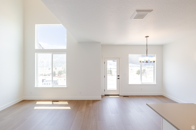 5224 South Acacia Drive, Unit 809 Mapleton, UT 84664 - Photo 5 of 23 Vaulted ceiling living space featuring a floor-to-ceiling window arrangement and wood-finish flooring