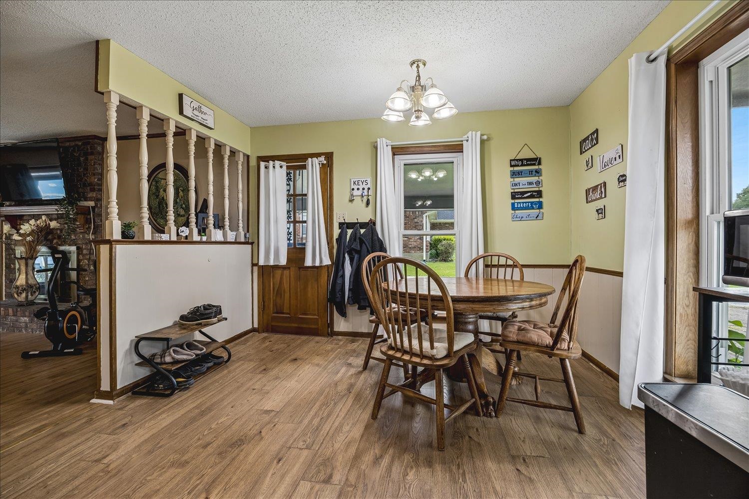 3284 Altruria Road Bartlett, TN 38134 - Photo 15 of 28 Open concept dining area featuring wood-finish flooring, a decorative chandelier, and natural light from multiple windows