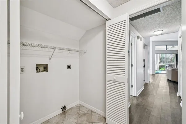 a view of a hallway with closet and wooden floor