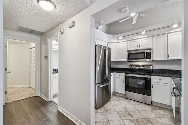 a kitchen with stainless steel appliances granite countertop a refrigerator and a sink