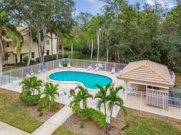 a view of a house with pool and sitting area