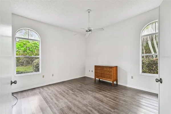 an empty room with windows and closet