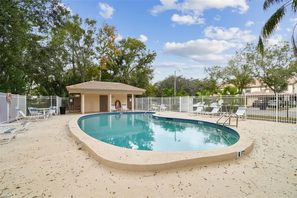 a view of a swimming pool with a yard