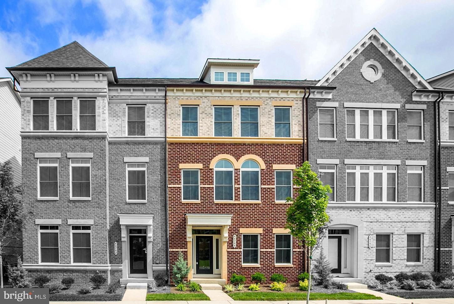 a front view of a residential apartment building with a yard