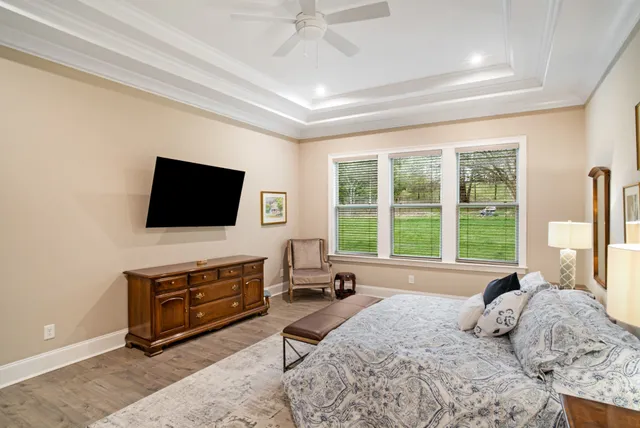 a bedroom with a bed and a chandelier