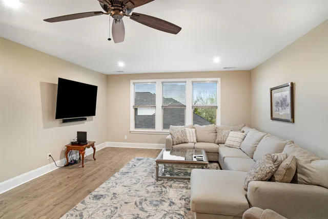 a front view of a house with a garden and yard