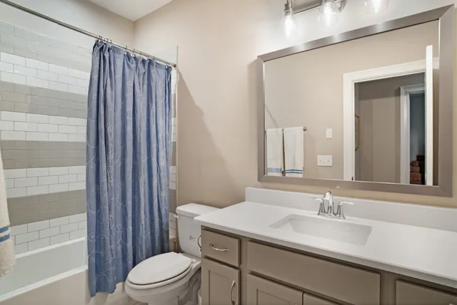 an aerial view of residential houses with outdoor space and trees