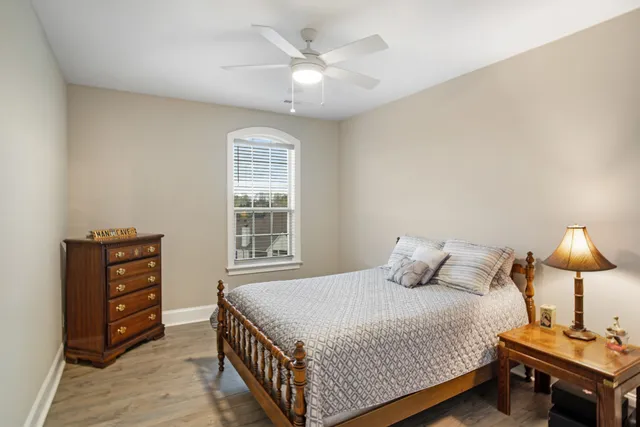 an aerial view of a swimming pool with outdoor seating and yard