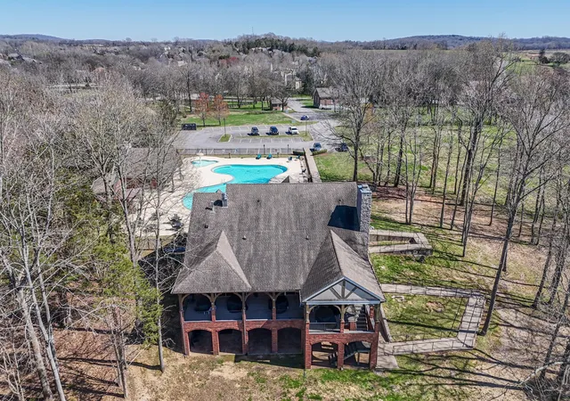 an aerial view of a house with garden space and street view