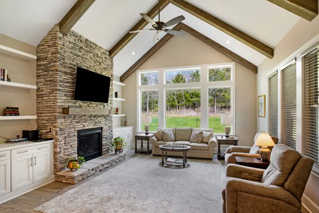 a kitchen with stainless steel appliances kitchen island granite countertop a sink a stove and chairs