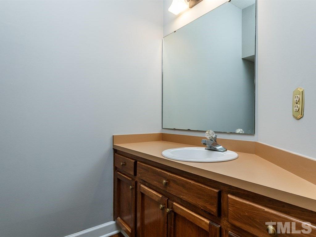 7651 Trowbridge Court Raleigh, NC 27613 - Photo 14 of 23 a bathroom with a sink and a mirror